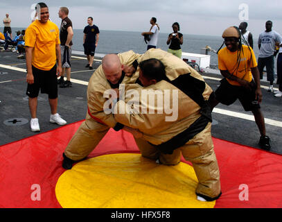 090214-N-3316L-109 ATLANTIC OCEAN (Feb. 14, 2009) Storekeeper 2nd Class Dale Newman and Hospital Corpsman 1st Class Karl Kho compete in a sumo wrestling contest during a steel beach picnic commemorating the 39th birthday of the amphibious transport dock ship USS Nashville (LPD 13). Nashville is deployed as part of Africa Partnership Station (APS) 2009, an international initiative developed by Naval Forces Europe and Naval Forces Africa, which aims to work cooperatively with U.S. and international partners to improve maritime safety and security for continent of Africa. (U.S. Navy photo by Mass Stock Photo