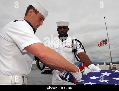 090408-N-9758L-079 PEARL HARBOR, Hawaii (April 8, 2009) A Naval Station Pearl Harbor flag detail, folds an American flag during an ashes scattering ceremony for Pearl Harbor survivor retired Capt. Demetrius Vellis at the USS Utah Memorial on Ford Island. Vellis was stationed aboard the destroyer USS Dale (DD 353) during the Dec. 7, 1941 attack on Pearl Harbor. More than 50 friends and family members paid their respects by dropping flower petals off the edge of the memorial. (U.S. Navy photo by Mass Communication Specialist 2nd Class Michael A. Lantron/Released) US Navy 090408-N-9758L-079 A Nav Stock Photo