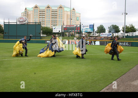 090506-N-5366K-002 FRISCO, Texas (May 6, 2009) Members of the U.S. Navy Parachute Team the Leap Frogs wave to a cheering crowd after parachuting into Dr. Pepper Ball Park. The Leap Frogs are scheduled to visit various schools in the Dallas area during the week and plan to jump into the SEAL Fitness Challenge at Keller ISD Natatorium May 9. The Team is based in San Diego and performs freefall demonstrations across the United States to showcase Navy excellence and raise awareness about Naval Special Warfare. (U.S. Navy photo by Mass Communication Specialist 2nd Class Michelle Kapica/Released) US Stock Photo