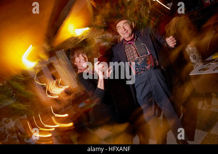 Middle aged couple dancing at party dressed in braces and having fun Stock Photo
