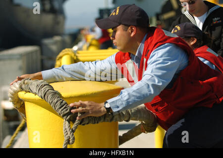 Line handlers secure mooring lines from the Royal Navy Invincible-class ...