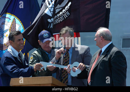 050801-N-7676W-629 San Diego, Calif. (Aug. 1, 2005) - Congressman Darrell Issa (R- San Diego), left, Congressman Randy Duke Cunningham (R-San Diego), left center, and Congressman Duncan Hunter (R-San Diego), right center, welcome Chairman of the Board, President and Chief Executive Officer of Titan Corporation, Dr. Gene W. Ray, right, to the podium during a welcoming ceremony for Sea Fighter (FSF 1). Developed by the Office of Naval Research (ONR), Sea Fighter is a high-speed aluminum catamaran that will test a variety of technologies that will allow the Navy to operate in littoral waters. U.S Stock Photo