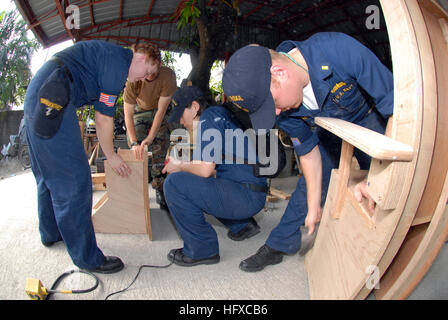 070209-N-9860Y-626 Manila, Philippines (Feb. 9, 2006) - Ensign Jeffrey Chewning of Germantown, Md., Fire Controlman 2nd Class Autumn Skalany of Crystal Lake, Ill., and Damage Controlman Fireman Abba Yeen Leon of Los Angeles, build furniture for children of Manila's Trichet Learning Center during a community service project. Amphibious command ship USS Blue Ridge (LCC 19) and embarked 7th Fleet staff are in the Philippines as part of Project Friendship, a humanitarian assistance/community service project with the armed forces of the Philippines. During Project Friendship, the ship will particip Stock Photo