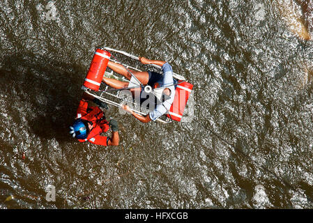 050830-C-3721C-071 New Orleans (Aug. 30, 2005) Ð U.S. Coast Guard Petty Officer 2nd Class Scott D. Rady of Tampa, Fla., gives the signal to hoist-up a pregnant woman from her apartment during a search and rescue (SAR) flight in New Orleans. The Coast Guard rescued 11 survivors from the apartment building that was flooded in the wake of Hurricane Katrina. A Category 4 hurricane, Katrina came ashore at approximately 7:10 a.m. EST near the Louisiana bayou town of Buras. U.S. Coast Guard photo by Petty Officer 2nd Class NyxoLyno Cangemi (RELEASED) US Navy 050830-C-3721C-071 U.S. Coast Guard Petty  Stock Photo