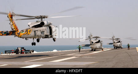 050910-N-6125G-149 Gulf of Mexico (Sept. 10, 2005) - An SH-60B Seahawk helicopter, assigned to the 'Battle Cats' of Helicopter Anti-Submarine Squadron Light Four Three (HSL-43), lands on the flight deck aboard the Nimitz-class aircraft carrier USS Harry S. Truman (CVN 75). Various Navy helicopter squadrons from across the country have been using Truman to conduct Hurricane Katrina relief flights. The Navy's involvement in the Hurricane Katrina humanitarian assistance operations are led by the Federal Emergency Management Agency (FEMA), in conjunction with the Department of Defense. U.S. Navy p Stock Photo