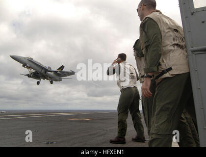 051013-N-4308O-061 Atlantic Ocean (Oct. 13, 2005) - Landing Signal Officers (LSO) observe and grade the arrested landing of an F/A-18C Hornet, assigned to the 'Gunslingers' of Strike Fighter Squadron One Zero Five (VFA-105), as it approaches the flight deck of the Nimitz-class aircraft carrier USS Harry S. Truman (CVN 75). Truman is currently conducting carrier qualifications and sustainment training with embarked Carrier Air Wing Three (CVW-3) off the East Coast of the United States. U.S. Navy photo by Photographer's Mate 3rd Class Ryan O'Connor (RELEASED) US Navy 051013-N-4308O-061 Landing S Stock Photo