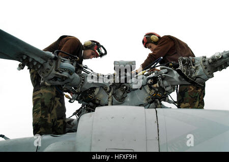 051027-N-1960H-034 USS KITTY HAWK (CV 63), At Sea (Oct. 27, 2005) - Sailors from Helicopter Attack Squadron (HS) 14 perform maintenance on the rotor assembly of an SH-60F Seahawk on the flight deck of USS Kitty Hawk (CV 63).  While at sea, Kitty Hawk and Carrier Strike Group 5 will participate in an annual military exercise with the Japanese Maritime Self Defense Force.  Currently underway in the western Pacific Ocean, the Kitty Hawk Carrier Strike Group demonstrates power projection and sea control as the U.S. Navy's only permanently forward-deployed aircraft carrier strike group, operating f Stock Photo
