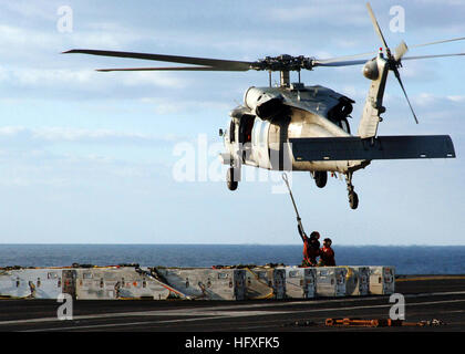 051103-N-6125G-071 Atlantic Ocean (Nov. 3, 2005) -  Aviation Ordnancemen attach ordnance to an MH-60S Seahawk helicopter, assigned to the 'Bay Raiders' of Helicopter Sea Combat Squadron Two Eight (HSC-28), on the flight deck of the Nimitz-class aircraft carrier USS Harry S. Truman (CVN 75). Truman is currently underway in the Atlantic Ocean conducting Ammunition Transfer with USS Enterprise (CVN 65) and USS Eisenhower (CVN 69). U.S. Navy photo by Photographer's Mate 3rd Class Eric Garst (RELEASED) US Navy 051103-N-6125G-071 Aviation Ordnancemen attach ordnance to an MH-60S Seahawk helicopter Stock Photo
