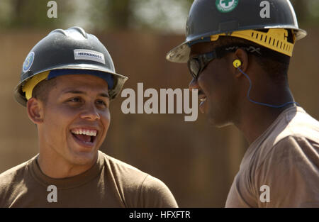 Constructionman Jaime Hernandez, Naval Mobile Construction Battalion 3, talks with his coworker Petty Officer 3rd Class Terence Ruben, Camp Lemonier, Djibouti, Nov. 8, 2005. The two new buildings will be used to combine and house the Joint Task Force-Horn of Africa's Future Operations personnel, who are currently separated in different work tents. (RELEASED) (U.S. Air Force photo by Staff Sgt. Stacy L. Pearsall) US Navy 051108-F-7234P-002 U.S. Navy Constructionman Jaime Hernandez, assigned to Naval Mobile Construction Battalion Three (NMCB-3), speaks with his co-worker, Petty Officer 3rd Class Stock Photo