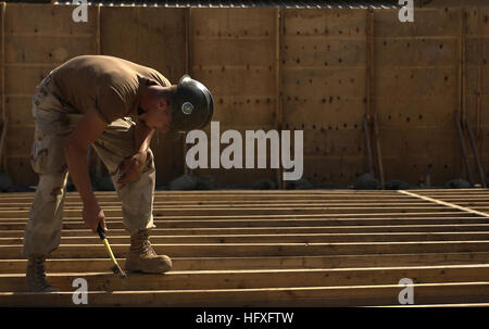 Inside a cordoned area, Constructionman Jaime Hernandez, Naval Mobile Construction Battalion 3, hammers nails into the floor boards, Camp Lemonier, Djibouti, Nov. 8, 2005. The two new buildings will be used to combine and house the Joint Task Force-Horn of Africa's Future Operations personnel, who are currently separated in different work tents. (RELEASED) (U.S. Air Force photo by Staff Sgt. Stacy L. Pearsall) US Navy 051108-F-7234P-048 Inside a cordoned area, U.S. Navy Constructionman Jaime Hernandez, assigned to Naval Mobile Construction Battalion Three (NMCB-3), hammers nails into floorboar