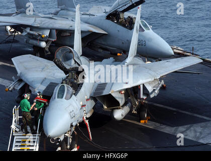 051116-N-5832A-001 Persian Gulf (Nov. 16, 2005) - Sailors assigned to the 'Tomcatters' of Fighter Squadron Three One (VF-31), conduct maintenance on one of their squadron's F-14D Tomcats on the flight deck the Nimitz-class aircraft carrier USS Theodore Roosevelt (CVN 71). Roosevelt and embarked Carrier Air Wing Eight (CVW-8) are currently underway in the Persian Gulf supporting Operation Steel Curtain, a joint U.S.-Iraqi military offensive aimed at preventing cells of Al Qaeda from entering Iraq through the Syrian border. U.S. Navy photo by Photographer's Mate Airman Derek Allen (RELEASED) US  Stock Photo