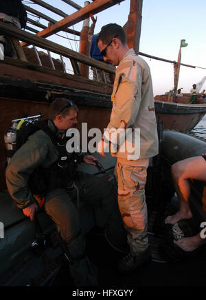 An officer from Explosive Ordnance Disposal Mobile Unit Two (EODMU-2), Detachment 22, conducts a pre-dive check on a safety diver’s rig during operations in the Persian Gulf to clear a fouled propeller on a Saudi Arabian fishing dhow. EODMU-2, Detachment 22, is part of Expeditionary Strike Group Eight (ESG-8) on deployment supporting global maritime security. Stock Photo