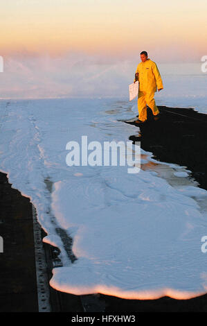 060106-N-5946V-015 Pacific Ocean (Jan. 6, 2006) - A crew member surveys the flight deck after lighting off the Aqueous Film Forming Foam (AFFF) system on the flight deck aboard the nuclear-powered aircraft carrier USS Nimitz (CVN 68). Nimitz is currently preparing for Inspection and Survey (INSURV). U.S. Navy photo by Photographer's Mate Airman Melissa Vanderwyst (RELEASED) US Navy 060106-N-5946V-015 A crew member surveys the flight deck after lighting off the Aqueous Film Forming Foam (AFFF) system Stock Photo