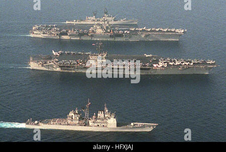 An aerial view of, from bottom to top, the guided missile cruiser USS SAN JACINTO (CG-56), the aircraft carriers USS JOHN F. KENNEDY (CV-67) and USS SARATOGA (CV-60) and ther guided missile cruiser USS BIDDLE (CG-34) underway. USS John F Kennedy (CV-67) and USS Saratoga (CV-60) underway crop Stock Photo