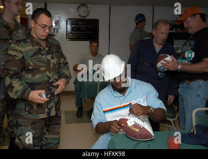 060209-N-4965F-009 Pearl Harbor, Hawaii (Feb. 9, 2006) - National Football League (NFL) New York JetsÕ linebacker, Jonathan Vilma, signs autographs for Sailors assigned to Amphibious Construction Battalion Two (ACB-2), during a visit to the Sea Based X-Band Radar (SBX). Vilma and other players visited various military installations while in Hawaii for the 2006 NFL Pro Bowl. The Pro Bowl, features All-Star players from the National Football Conference (NFC) and the American Football Conference (AFC) in a game, which will be played for the 27th consecutive year at Aloha Stadium in Honolulu, Hawa Stock Photo