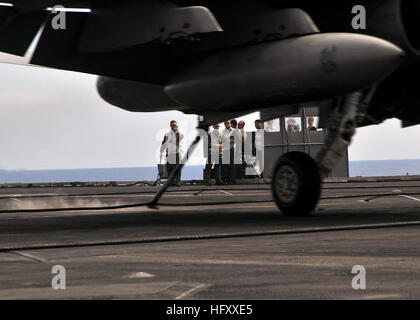 Landing signal officers observe an F/A-18C Hornet, assigned to the Golden Dragons of Strike Fighter Squadron (VFA) 192, make an arrested landing on the aircraft carrier USS George Washington (CVN 73). George Washington, the Navy's only permanently forward deployed aircraft carrier, is participating in Annual Exercise, a yearly bilateral exercise with the U.S. Navy and the Japan Maritime Self-Defense Force. USS George Washington (CVN 73) DVIDS223336 Stock Photo