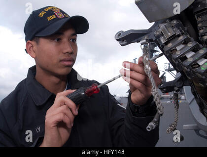 YOKOSUKA, Japan (Jan. 28, 2010) Fire Controlman 3rd Class Brian Ly, from Roswell, N.M., performs preventative maintenance on a Close-In Weapons System (CIWS) mount aboard the Arleigh Burke-class guided-missile destroyer USS Curtis Wilbur (DDG 54). Curtis Wilbur is assigned to Destroyer Squadron (DESRON) 15 and operates from Yokosuka, Japan. (U.S. Navy photo by Mass Communication Specialist Seaman Mike R. Mulcare/Released) US Navy 100128-N-5019M-001 Fire Controlman 3rd Class Brian Ly performs preventative maintenance on a Close-In Weapons System (CIWS) Stock Photo