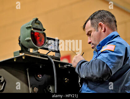 100209-N-6889J-050  GULFPORT, Miss. (Feb. 9, 2010) Frank Carroll, a civilian mechanic assigned to the construction equipment division of Naval Facilities Expeditionary Logistics Center, in Gulfport, Miss., installs a new LED lighting system on an up-armored backhoe. The construction equipment division is up-armoring and preparing civil engineer support equipment to send to Afghanistan. (U.S. Navy photo by Mass Communication Specialist 2nd Class Gregory N. Juday/Released) US Navy 100209-N-6889J-050 Frank Carroll, a civilian mechanic assigned to the construction equipment division of Naval Facil Stock Photo