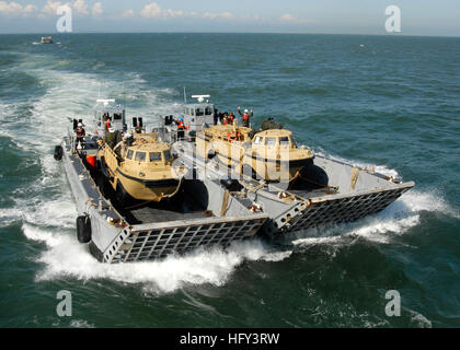 100313-N-9301W-084  MOOREHEAD CITY, N.C. (March 13, 2010) Two landing craft mechanized (LCM 8) carry vehicles to the amphibious dock landing ship USS Fort McHenry (LSD 43) before its departure. Fort McHenry has returned from participating in Operation Unified Response by providing military support capabilities to civil authorities to help stabilize and improve the situation in Haiti following a 7.0 magnitude earthquake on Jan. 12. (U.S. Navy photo by Mass Communication Specialist 1st Class Darryl I. Wood/Released) US Navy 100313-N-9301W-084 Landing craft mechanized transport vehicles to the am Stock Photo