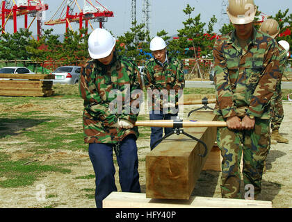 100317-N-9573A-017 BUSAN, Republic of Korea (March 17, 2010) Builder 3rd Class Douglas Norris, from Spokane, Wash., assigned to Naval Mobile Construction Battalion (NMCB) 1, leads a team of Republic of Korean navy Seabees as they move a timber block during construction of a timber tower as part of exercise Key Resolve/Foal Eagle 2010. Key Resolve/Foal Eagle 2010 involves U.S. service members and South Korean service members working together during computer-based simulations exercises and a series of field exercises. (U.S. Navy photo by Mass Communication Specialist 1st Class Bobbie G. Attaway/ Stock Photo