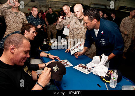 100328-N-8936G-226 DJIBOUTI (March 28, 2010) New Orleans Saints tight end Billy Miller, left, and New Orleans Saints quarterback Drew Brees sign autographs for Sailors and Marines in the hangar bay of the amphibious assault ship USS Nassau (LHA 4). Miller and Brees visited Nassau as part of a USO Tour. Nassau is the command platform for the Nassau Amphibious Ready Group supporting maritime security operations and theater security cooperation operations in the U.S. 5th Fleet area of responsibility. (U.S. Navy photo by Mass Communication Specialist 2nd Class Patrick Gordon/Released) US Navy 1003 Stock Photo