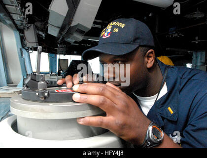 100330-N-1559J-005 ATLANTIC OCEAN (March 30, 2010) Ensign Antwan Richardson takes bearing readings on the bridge of the guided-missile destroyer USS Laboon (DDG 58) while in transit to Scotland to participate in Joint Warrior. Joint Warrior is a semi-annual event that encompasses multi-national and multi-warfare exercises designed to improve interoperability between allied navies and prepares participating crews to conduct combined operations during deployment. (U.S. Navy photo by Mass Communication Specialist 1st Class Darius O. Jackson/released) US Navy 100330-N-1559J-005 Ensign Antwan Richa Stock Photo