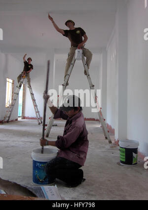 100525-N-0827C-001  QUY NHON, Vietnam (May 25, 2010) Engineering Aide Constructionman Christopher Kelly and Builder Constructionman John McClure, both assigned to Naval Mobile Construction Battalion (NMCB) 11, paint the ceiling of the Hope Center engineering site while Trung Dinh Vu, a Vietnamese volunteer, mixes paint. The engineering project is part of Pacific Partnership 2010, the fifth in an annual series of U.S. Pacific Fleet humanitarian and civic assistance endeavors aimed at strengthening regional partnerships. (U.S. Navy photo by Lt. Cmdr. Arwen Consaul/Released) US Navy 100525-N-0827 Stock Photo