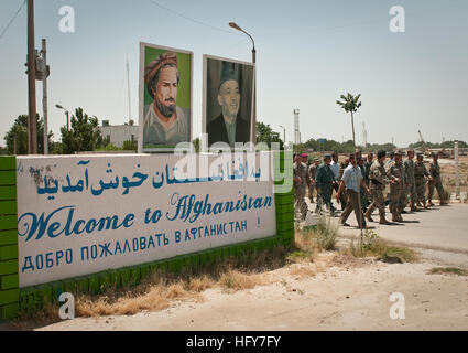 BALKH PROVINCE, Afghanistan (May 27, 2010) — General Stanley McChrystal, commander of NATO’s International Security Assistance Force, the Mayor of Hairaton, provincial officials and members of the  Afghan Border Police pass the “Welcome to Afghanistan” sign on their way to the Freedom Bridge crossing the Amu Darya River. On 15th February, 1989 the last Soviet troops to withdraw from Afghanistan crossed the bridge into the, then, Uzbek Soviet Socialist Replublic. (U.S. Navy photo by Petty Officer 1st Class Mark O’Donald/Released) Welcome to Afghanistan in Hairatan Stock Photo