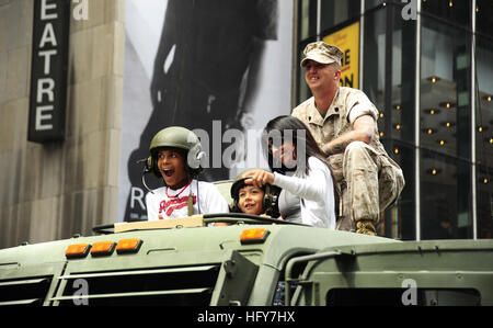 100528-N-5878L-027  NEW YORK (May 28, 2010) U.S. Marine Sgt. Matthew Waller, from St. Louis, poses for a photo on top of a Marine Corps vehicle with visitors in Times Square during Fleet Week New York 2010. Approximately 3,000 Sailors, Marines and Coast Guardsmen are participating in the 23rd Fleet Week New York, which will take place May 26 through June 2. Fleet Week has been New York City's celebration of the sea services since 1984. (U.S. Navy photo by Mass Communication Specialist Seaman Eric Lockwood/Released) US Navy 100528-N-5878L-027 U.S. Marine Sgt. Matthew Waller, from St. Louis, pos Stock Photo