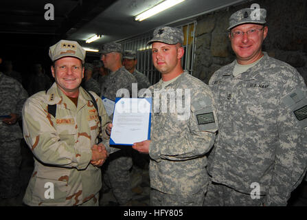 Kabul, Afghanistan - Vice Adm. Bill Gortney, left, Commander, U.S. Navy Forces Central Command/5th Fleet, stands with newly frocked Petty Officer 2nd Class Jarod Newlove and his sponsor, Chief Petty Officer Patrick Myers, during a frocking ceremony on Camp Eggers. During his visit to Camp Eggers, the headquarters of NATO Training Mission - Afghanistan, Gortney met with command staff, officiated at a frocking ceremony for six Sailors and spoke openly to Sailors about the importance of their mission in Afghanistan.(US Navy Photo by Chief Mass Communication Specialist F. Julian Carroll)RELEASED V Stock Photo