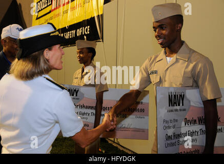100911-N-4995K-074   MEMPHIS, Tenn. (Sept. 11, 2010) Rear Adm. Robin Graf, deputy commander of Navy Recruiting Command shakes hands with Midshipmen Devin Woodfork after presenting him with a Naval ROTC scholarship check during the 21st Southern Heritage Classic football game at Liberty Stadium. Sailors from across Navy Recruiting District Nashville attended multiple events during the Southern Heritage Classic cultural celebration to foster diversity in recruiting throughout the region.  (U.S. Navy photo by Mass Communication Specialist 2nd Class Chelsea Kennedy/Released) US Navy 100911-N-4995K Stock Photo
