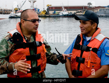 100920-N-9095H-008  LIMA, Peru (Sept. 20, 2010) Chief Boatswain's Mate Jack Bustillos, left, mission commander of the security force assistance mobile training team, explains coxswain tactical maneuvers to a Peruvian coast guardsman aboard the Peruvian patrol boat PC 228 Coishco during small boat patrol training. The team is a component of Maritime Civil Affairs Security and Training Command and is deployed to Peru to instruct and train the Peruvian coast guard as a means to enhance their small boat patrol capabilities. (U.S. Navy photo by Mass Communication Specialist 2nd Class Michael R. Hin Stock Photo