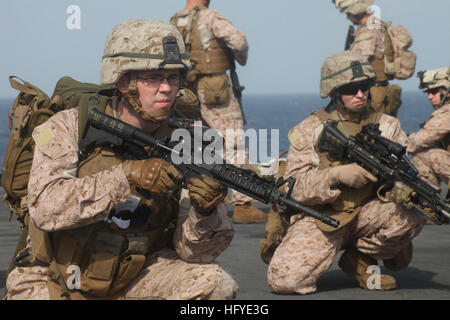 100923-M-4471M-007 U.S. 5TH FLEET AREA OF RESPONSIBILITY (Sept. 23, 2010) Seaman Chadwick Bookout, left, a hospital corpsman assigned to Weapons Company, Battalion Landing Team 3/8, 26th Marine Expeditionary Unit (26th MEU), provides security during a tactical recovery of aircraft and personnel exercise on the flight deck of the amphibious assault ship USS Kearsarge (LHD 3). The Marines and Sailors of the 26th MEU and the ships of the Kearsarge Amphibious Ready Group are deployed to support Pakistan flood relief efforts. (U.S. Marine Corps photo by Master Sgt. Christopher A. Matt/Released) US  Stock Photo