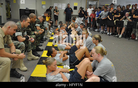 101016-N-7361H-004   NEW PORT RICHEY, Fla. (Oct 16, 2010) Navy Junior ROTC students from Lemon Bay High School perform sit-ups during the sit-up competition at the 3rd annual Mitchell Mustang Stampede at J. W. Mitchell High School. NJROTC units from schools throughout Florida gathered to compete in personnel inspection, drill, color guard, academics and athletics. The students were timed by volunteer Sailors, Marines and Midshipmen from various Florida commands. (U.S. Navy photo by Mass Communication Specialist 2nd Class Jennifer P. Harman/Released) US Navy 101016-N-7361H-004 Navy Junior ROTC  Stock Photo