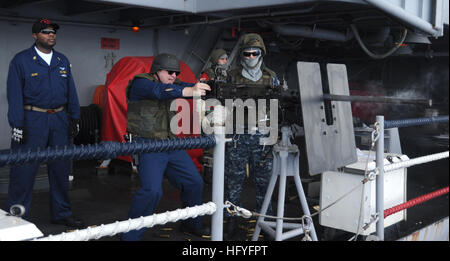 101030-N-8721D-092 PACIFIC OCEAN (Oct. 30, 2010) Cmdr. John Lund, from Silverdale, Wash., chief engineer aboard the aircraft carrier USS George Washington (CVN 73), fires an M2 .50-caliber machine gun from the ship's fantail during a live-fire exercise. George Washington, the Navy's only permanently forward-deployed aircraft carrier, is underway helping to ensure security and stability in the western Pacific Ocean. (U.S. Navy photo by Mass Communication Specialist 3rd Class Devon Dow/Released) US Navy 101030-N-8721D-092 Cmdr. John Lund, from Silverdale, Wash., chief engineer aboard the aircraf Stock Photo