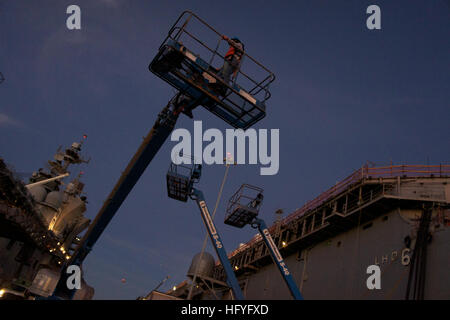 101104-N-9643K-185  SAN DIEGO (Nov. 4, 2010) A shipyard worker positions a lift to begin hull preservation work on the amphibious assault ship USS Bonhomme Richard (LHD 6). Bonhomme Richard is preparing for a months-long maintenance period. (U.S. Navy photo by Chief Mass Communication Specialist Joe Kane/Released) US Navy 101104-N-9643K-185 A shipyard worker positions a lift to begin hull preservation work on the amphibious assault ship USS Bonhomme Richard ( Stock Photo