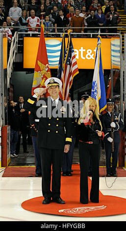 101111-N-7863V-104 DETROIT (Nov. 11, 2010) Rear Adm. John Jolliffe, Vice Commander of U.S. Naval Forces Central Command, salutes the national ensign before a Detroit Red Wings game on Military Appreciation Night. Jolliffe, from Detroit, escorted national anthem singer Karen Newman on the ice at Joe Louis Arena before the televised game against the Edmonton Oilers. (U.S. Navy photo/Released) US Navy 101111-N-7863V-104 Rear Adm. John Jolliffe, Vice Commander of U.S. Naval Forces Central Command, salutes the national ensign before a Detro Stock Photo