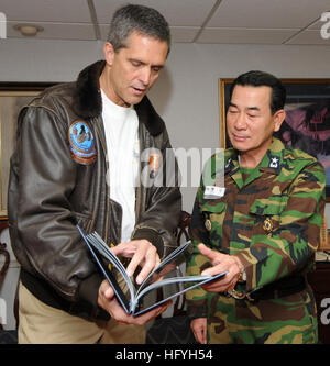 Capt. David Lausman, commanding officer of the aircraft carrier USS George Washington, presents a photo album to Republic of Korea Navy Adm. Beon-rim Lee. George Washington is in the waters west of the Korean peninsula participating in a training exercise with the Republic of Korea Navy. USS George Washington captain visits Korean admiral DVIDS345412 Stock Photo