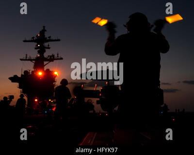 110205-N-7981E-173 ARABIAN SEA (Feb. 5, 2011) An aircraft director guides an E-2C Hawkeye assigned to Carrier Airborne Early Warning and Control Squadron (VAW) 125 onto the bow catapults aboard the Nimitz-class aircraft carrier USS Carl Vinson (CVN 70). The Carl Vinson Carrier Strike Group is deployed supporting maritime security operations and theater security cooperation efforts in the U.S. 5th Fleet area of responsibility. (U.S. Navy photo by Mass Communication Specialist 2nd Class James R. Evans/Released) US Navy 110205-N-7981E-173 An aircraft director guides an E-2C Hawkeye assigned to Ca Stock Photo