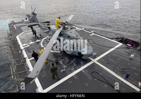 110323-N-SF508-027 PACIFIC OCEAN (March 23, 2011) Sailors assigned to the Warlords of Helicopter Anti-Submarine Squadron Light (HSL) 51 decontaminate an SH-60B Sea Hawk helicopter aboard the Ticonderoga-class guided-missile cruiser USS Shiloh (CG 67) during a radiation survey and decontamination evolution. Shiloh is off the northeastern coast of Japan conducting humanitarian assistance operations as part of Operation Tomodachi. (U.S. Navy photo by Mass Communication Specialist 3rd Class Charles Oki/Released) US Navy 110323-N-SF508-027 Sailors assigned to the Warlords of Helicopter Anti-Submari Stock Photo