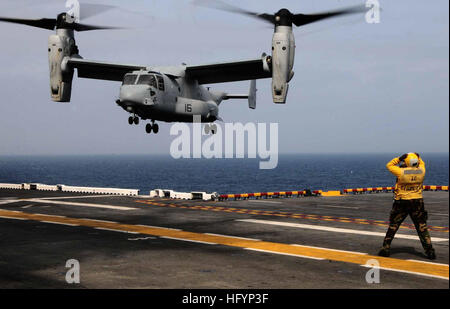 110411-N-7508R-004 ATLANTIC OCEAN (April 11, 2011) An aircraft director guides an MV-22B Osprey assigned to Marine Medium Tiltrotor Squadron (VMM) 263 (Reinforced) to a landing aboard the multipurpose amphibious assault ship USS Bataan (LHD 5). Bataan is deploying to the Mediterranean Sea. (U.S. Navy photo by Mass Communication Specialist 2nd Class Julio Rivera/Released) US Navy 110411-N-7508R-004 An aircraft director guides an MV-22B Osprey assigned to Marine Medium Tiltrotor Squadron (VMM) 263 (Reinforced) to a la Stock Photo