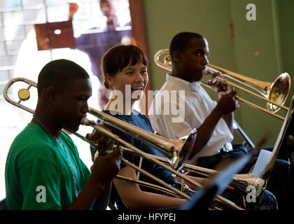 110420-N-RM525-033 KINGSTON, Jamaica (April 20, 2011) Musician 3rd Class Loralee Swanson, from Rapid City, S.D., listens as trombone players from the Alpha Boys School concert band play a song during a Continuing Promise 2011 subject matter expert exchange at the Alpha Boys School. Continuing Promise is a five-month humanitarian assistance mission to the Caribbean, Central and South America. (U.S. Navy photo by Mass Communication Specialist 2nd Class Jonathen E. Davis/Released) US Navy 110420-N-RM525-033 Musician 3rd Class Loralee Swanson, from Rapid City, S.D., listens as trombone players fro Stock Photo
