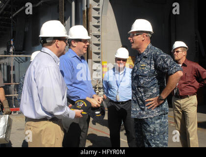 110503-N-7451A-007 SAN DIEGO (May 3, 2011) Kevin Cooley, Assistant Deputy Chief Management Officer for the Navy, Brian Marsh, head of the Communications and Networks Department, Space and Naval Warfare Systems Center Pacific, and Capt. Jonathan Harnden, commanding officer of the amphibious assault ship USS Bonhomme Richard (LHD 6), tour network and communications spaces to view the progress of new equipment being installed aboard the ship.  Bonhomme Richard recently completed a four-month dry dock period. (U.S. Navy photo by Mass Communication Specialist 1st Class Janell Alvarez/Released) US N Stock Photo