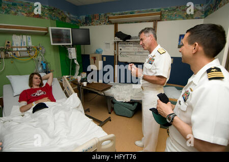 110525-N-HZ247-149 WILMINGTON, Del. (May 25, 2011) Vice Chief of Information Rear Adm. Kenneth Braithwait and Cmdr. Gus Gutierrez, commanding officer of the ballistic missile submarine USS Pennsylvania (SSBN 735), talk to a patient at the AI Dupont Children's Hospital about becoming a U.S. Navy SEAL at a Caps for Kids event during Philadelphia Navy Week 2011. Navy Weeks are designed to show Americans the investment they have made in their Navy, A Global Force for Good, and increase awareness in cities that do not have a significant Navy presence. (U.S. Navy photo by Mass Communication Speciali Stock Photo