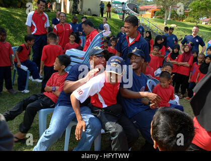 110607-N-NJ145-074 KUANTAN, Malaysia (June 7, 2011) Malaysian and U.S. Navy Sailors play musical chairs with children from the Rumah Kanak Orphanage during a Cooperation Afloat Readiness and Training (CARAT) Malaysia 2011 community service project. CARAT is a series of bilateral exercises held annually in Southeast Asia to strengthen relationships and enhance force readiness. (U.S. Navy photo by Mass Communication Specialist 1st Class Robert Clowney/Released) US Navy 110607-N-NJ145-074 Malaysian and U.S. Navy Sailors play musical chairs with children from the Rumah Kanak Orphanage during a Coo Stock Photo