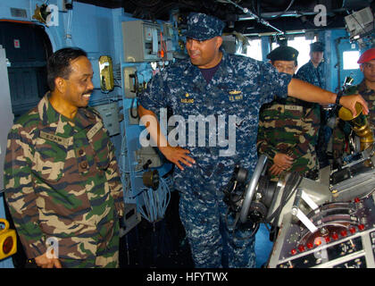 110607-N-VY256-031 KUANTAN, Malaysia (June 7, 2011) Cmdr. Adrian Ragland, commanding officer of the amphibious dock landing ship USS Tortuga (LSD 46), explains BoatswainÕs Mate of the Watch duties to Malaysian Armed Forces Brig. Gen. Ezam Bin Wanchik and other Malaysian officers during a tour supporting Cooperation Afloat Readiness and Training (CARAT) Malaysia 2011. CARAT is a series of bilateral exercises held annually in Southeast Asia to enhance relationships and support mission readiness. (U.S. Navy photo by Mass Communication Specialist 3rd Class Christopher S. Johnson/Released) US Navy  Stock Photo