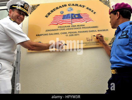 110611-N-NJ145-125 KAMPONG SALONG, Malaysia (June 11, 2011) Capt. John W. Gilman, theater security cooperation director at Commander, Task Force (CTF) 73 and Royal Malaysian Navy Rear Adm. Nasaruddin bin Othman, assistant chief of staff, sign the dedication plaque during the turnover ceremony for a new medical clinic built by U.S. Navy Seabees and Malaysian army engineers during Cooperation Afloat Readiness and Training (CARAT) Malaysia 2011. CARAT is a series of bilateral exercises held annually in Southeast Asia to strengthen relationships and enhance force readiness. (U.S. Navy photo by Mas Stock Photo