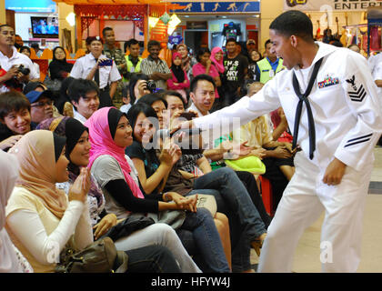 110610-N-VP123-137 KUANTAN, Malaysia  (June 10, 2011) Musician 1st Class Christopher Sams enlists the help of the audience for a Michael Jackson song during a concert at Kuantan Parade Mall as part of Cooperation Afloat Readiness and Training (CARAT) Malaysia 2011. CARAT is a series of bilateral exercises held annually in Southeast Asia to strengthen relationships and enhance force readiness. (U.S. Navy photo by Lt. Cmdr. Mike Morley/Released) US Navy 110610-N-VP123-137 Musician 1st Class Christopher Sams enlists the help of the audience for a Michael Jackson song during a concert at Kuan Stock Photo