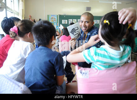 110624-N-VE260-657  AYASE CITY, Japan (June 24, 2011) Aviation Boatswain's Mate Handling 2nd Class Raymond Tangi, assigned to Naval Air Facility Atsugi, teaches the months of the year in English to elementary students at Terao Elementary School for the Assisted Language Teaching Program. The program has been active for 14 years and has helped build a closer relationship between local U.S. military and the surrounding communities. (U.S. Navy photo by Mass Communication Specialist 2nd Class Justin Smelley/Released) US Navy 110624-N-VE260-657 Aviation Boatswain's Mate Handling 2nd Class Raymond T Stock Photo