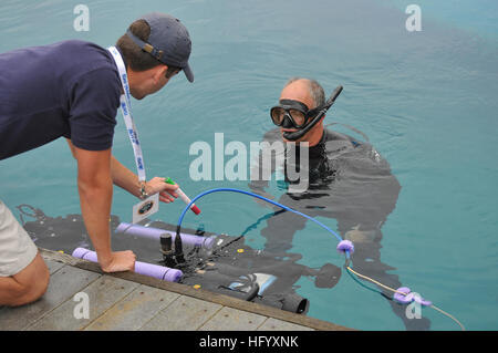 110713-N-UN340-006 SAN DIEGO (July 13, 2011) Space and Naval Warfare Systems Center (SSC) Pacific diver John Pryor assists University of Florida team member, Patrick Walters, with in-water checks to the universityÕs Subjugator, an autonomous underwater vehicle, during the 14th annual International RoboSub Competition at SSC Pacific.  The contest, co-sponsored by the Office of Naval Research and the Association for Unmanned Vehicle Systems International (AUVSI), attracted more than 200 students from 30 schools and seven countries. (U.S. Navy photo by Rick Naystatt/Released) US Navy 110713-N-UN3 Stock Photo